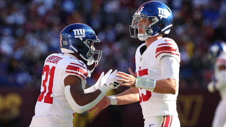 Matt Breida, left, and Tommy DeVito of the Giants celebrate after a...