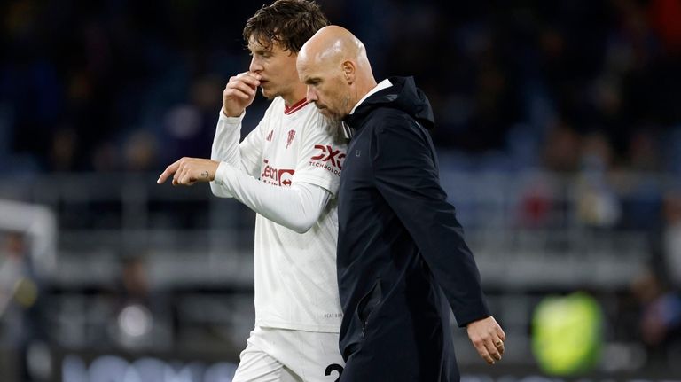 Manchester United Manager, Erik ten Hag, right, interacts with Manchester...