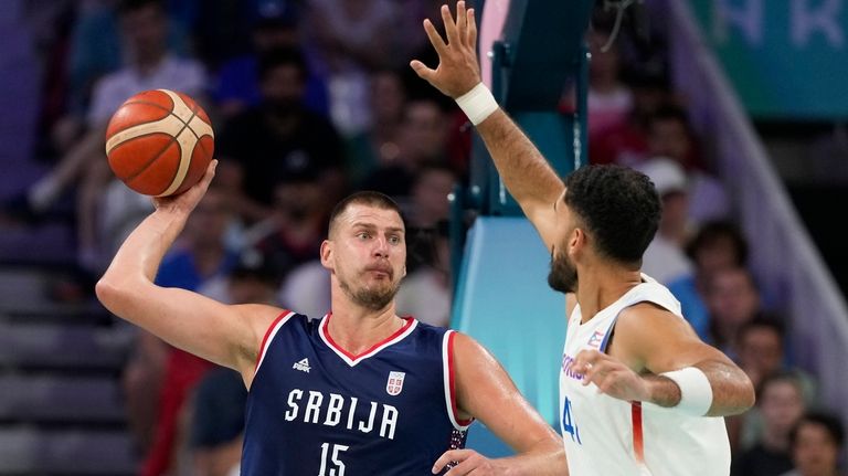 Nikola Jokic, of Serbia, makes a pass over Arnaldo Toro,...