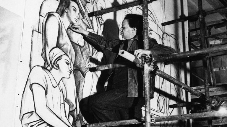 Mexican artist Diego Rivera traces the outline of a fresco...