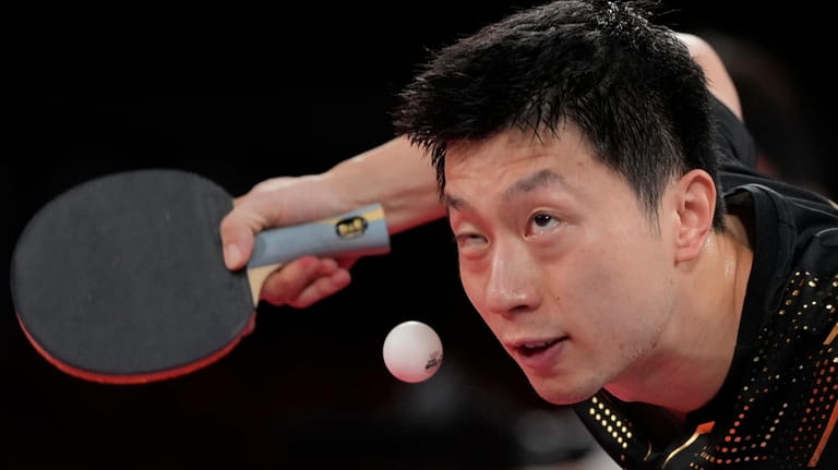China's Ma Long serves the ball during the table tennis...