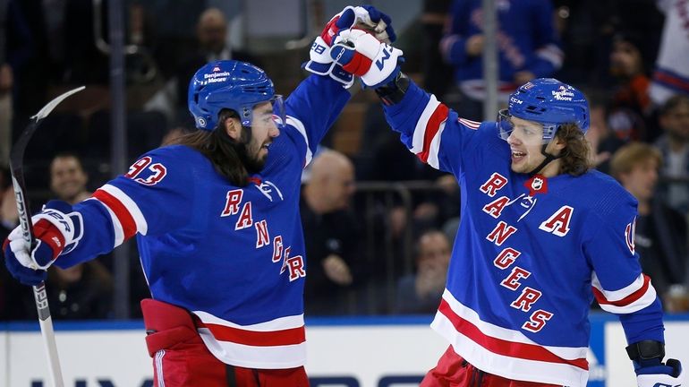 Rangers center Mika Zibanejad, left, congratulates Artemi Panarin after Panarin's...