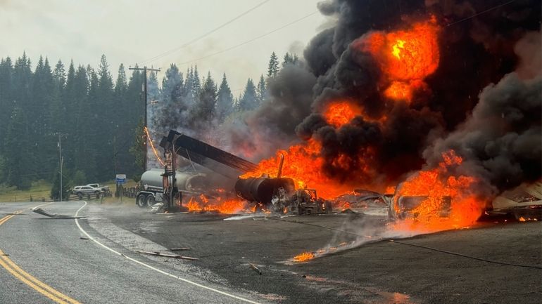 A fire burns at the gas station after an explosion...