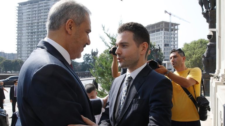 Turkish Foreign Minister Hakan Fidan, left, is welcomed by North...