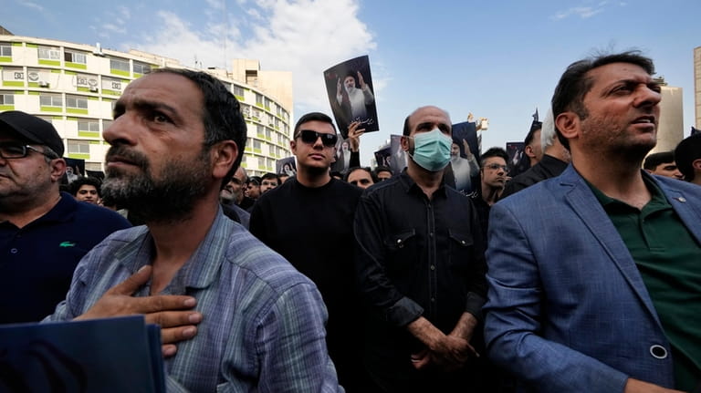 People attend a mourning ceremony for Iranian President Ebrahim Raisi,...