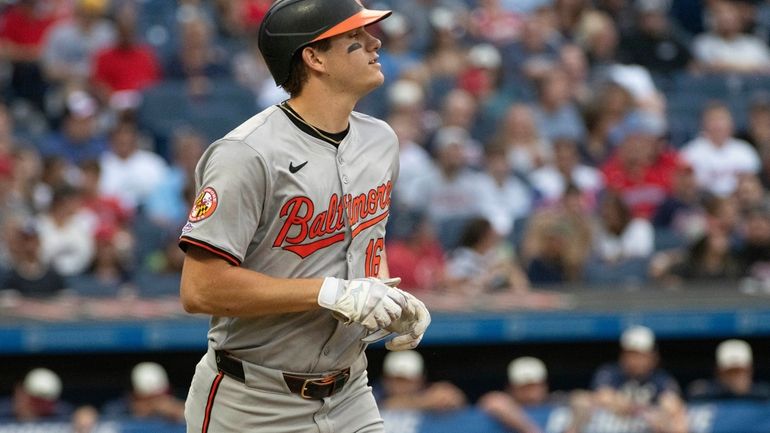 Baltimore Orioles' Coby Mayo heads to first base with a...