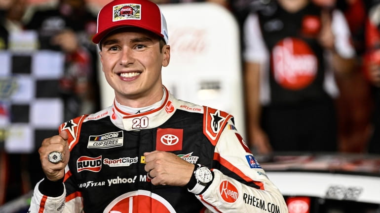 Driver Christopher Bell celebrates in Victory Lane after winning a...