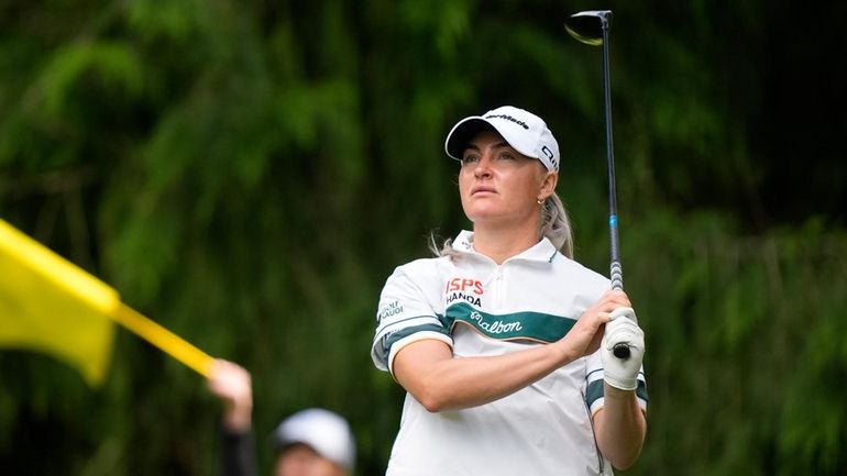 Charley Hull, of England, watches her shot after hitting from...