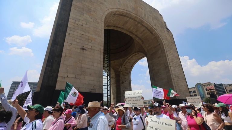 Federal court workers gather outside the Monument to the Revolution...