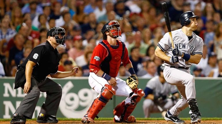 Mark Teixeira hits a two-run triple in the seventh inning....