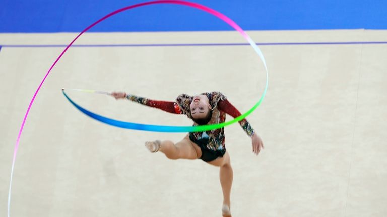 A member of team China performs with a ribbon in...