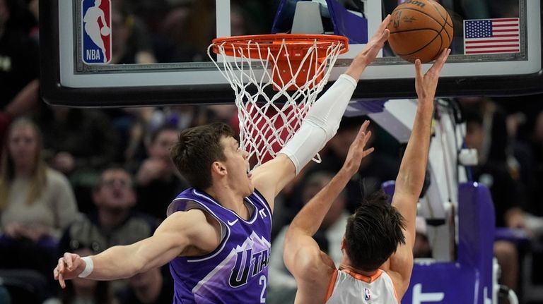 Utah Jazz center Walker Kessler, left, blocks a shot by...