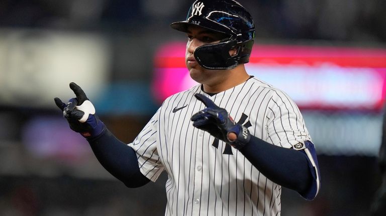 New York Yankees' Jose Trevino gestures to his dugout after...