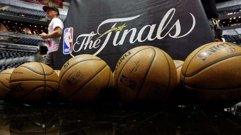 NBA basketballs and the NBA Finals logo are seen on...