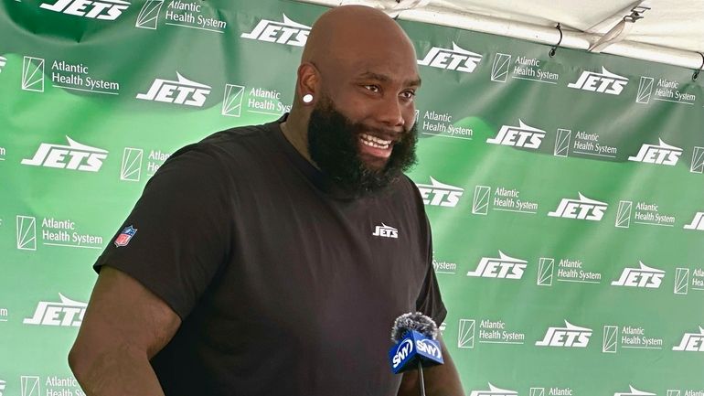 Jets offensive tackle Morgan Moses speaks to reporters after his...