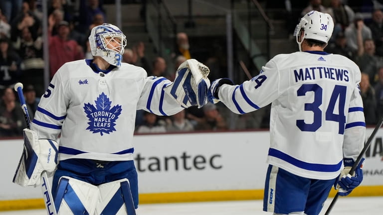 Toronto Maple Leafs center Auston Matthews (34) celebrates with goaltender...