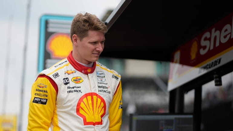 Josef Newgarden stands in his pit box during a practice...