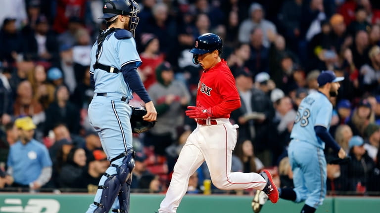 Boston Red Sox's Masataka Yoshida scores in front of Toronto...