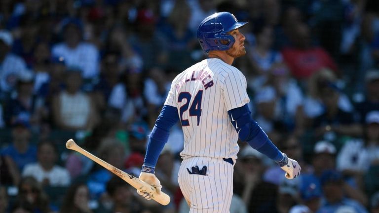 The Cubs' Cody Bellinger reacts after striking out during the...