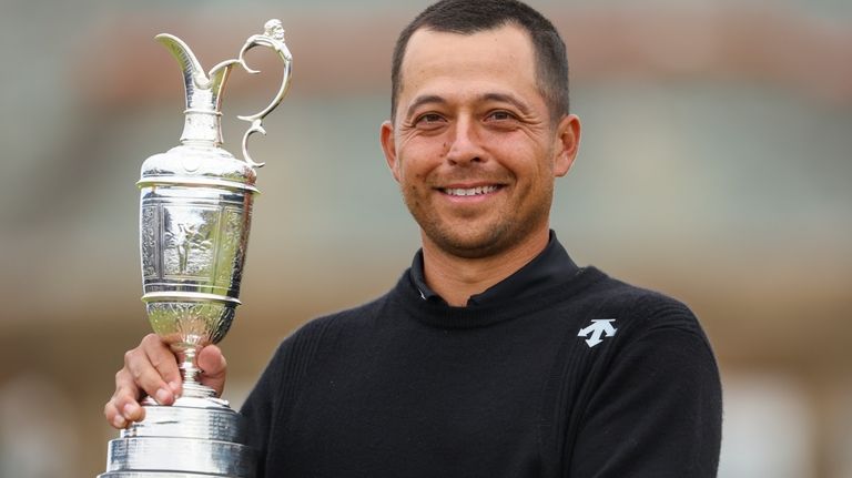 Xander Schauffele of the United States holds the Claret Jug...