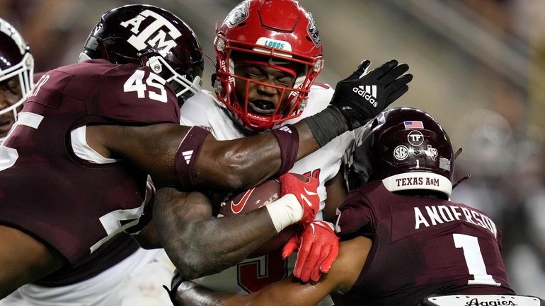 New Mexico running back Jacory Croskey-Merritt (5) is tackled by...