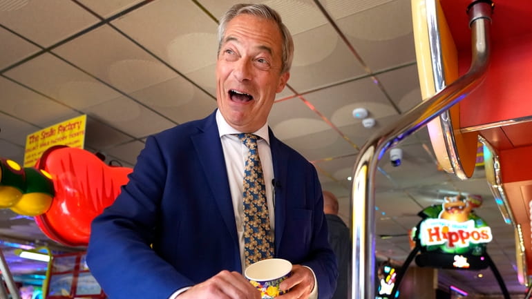 Britain's Nigel Farage, Reform UK party leader plays on a...
