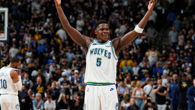Minnesota Timberwolves guard Anthony Edwards gestures as time runs out...