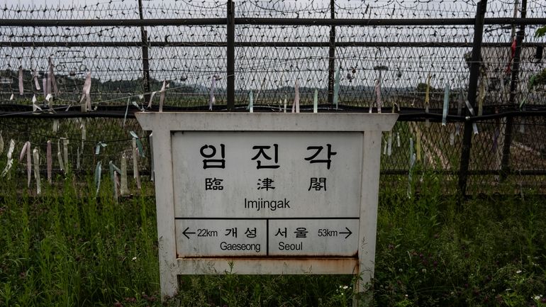 A directional sign showing the distance to North Korea's Kaesong...