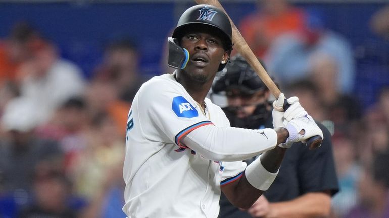 The Marlins' Jazz Chisholm Jr. reacts after striking out swinging...