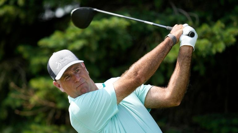 Stewart Cink watches his tee shot on the second hole...