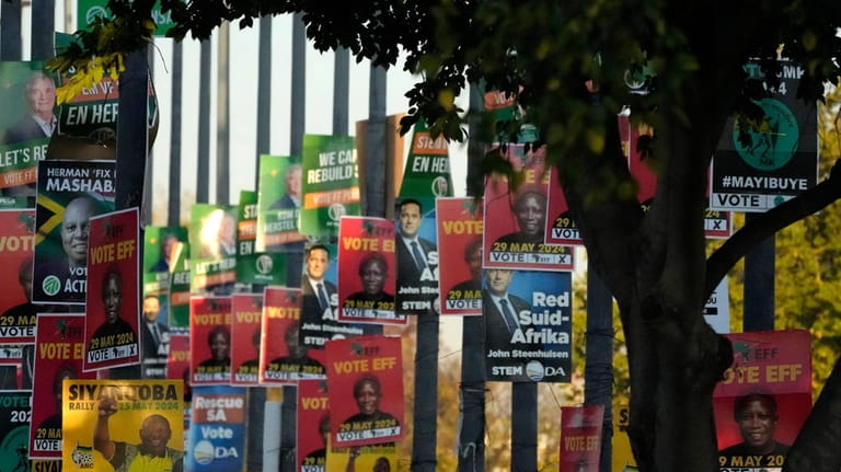 FILE — An array of election posters from various political...