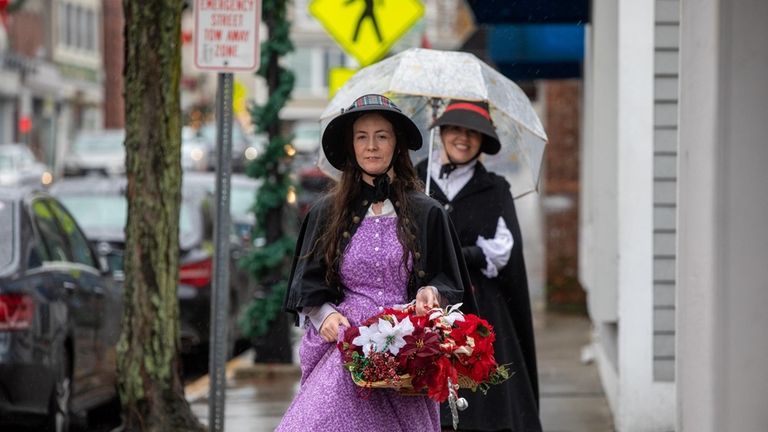 Street performer "Mrs. Sourbury" walks on main street at the...