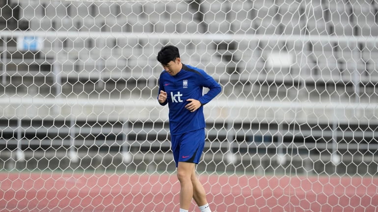 South Korea's Son Heung-min warms up during an open training...