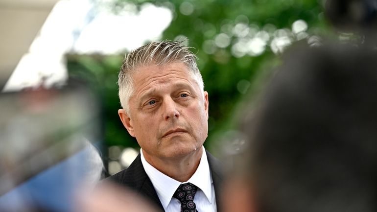 Former vice-admiral Haydn Edmundson listens to questions outside the courthouse...