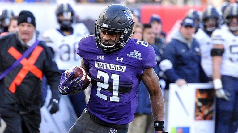 Northwestern running back Justin Jackson runs for a 16-yard touchdown...