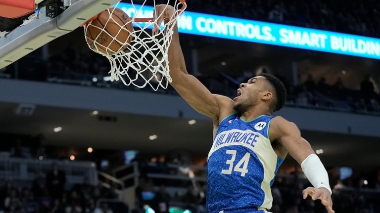 Milwaukee Bucks' Giannis Antetokounmpo dunks during the second half of...