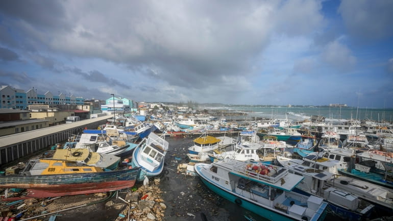 Fishing vessels lie damaged after Hurricane Beryl passed through the...