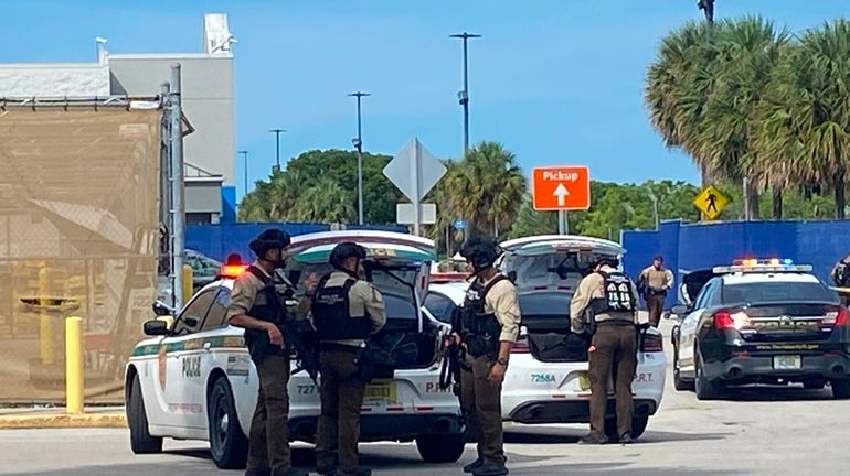 Police surround a Walmart in Florida City, Fla., about 25...