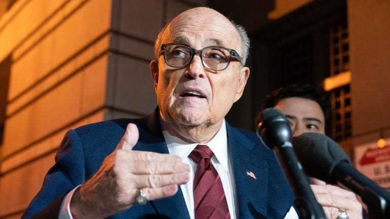 Former New York Mayor Rudy Giuliani talks to reporters as...