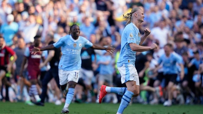 Manchester City's Erling Haaland, right, and Manchester City's Jeremy Doku...