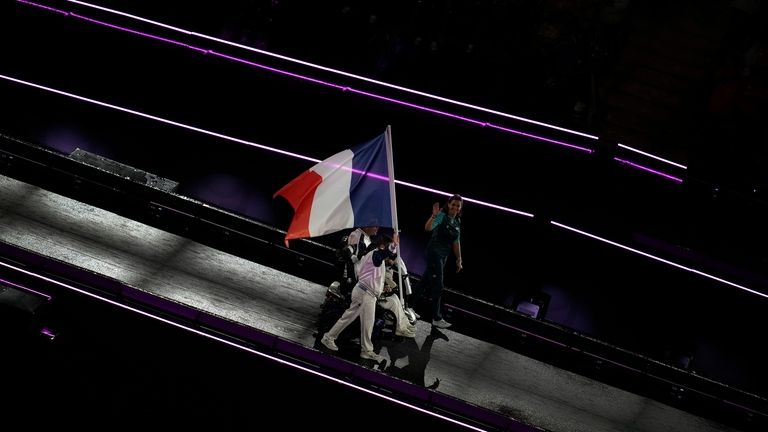 Members of the French delegation parade during the closing ceremony...