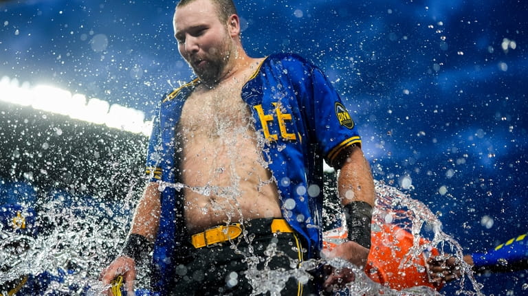 Seattle Mariners' Cal Raleigh is doused by teammates he hit...