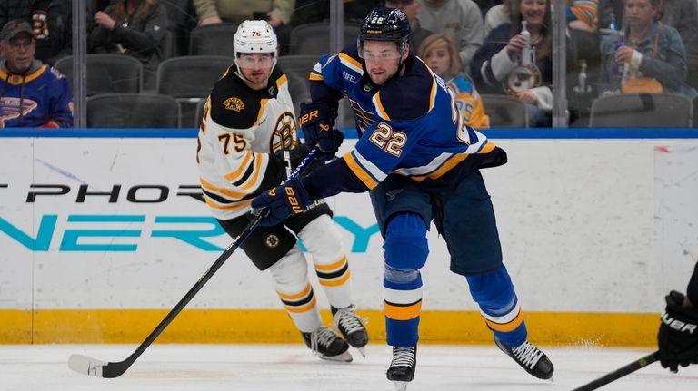 St. Louis Blues' Logan Brown (22) reaches for a loose...