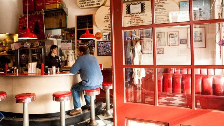 A diner sits at the bar at Glen's Dinette in...