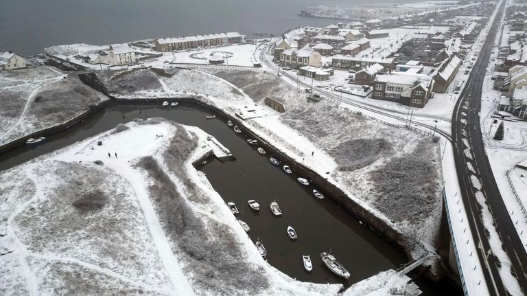 Snow blanketed Seaton Sluice in Northumberland, England, Sunday, Dec. 3,...