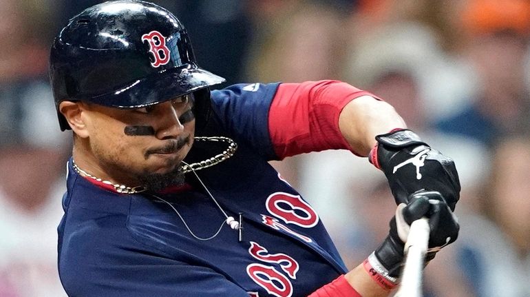 Mookie Betts of the Boston Red Sox hits a double...