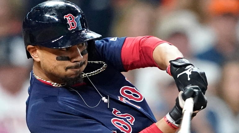Mookie Betts of the Boston Red Sox hits a double...