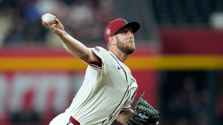 Arizona Diamondbacks pitcher Merrill Kelly throws against the Texas Rangers...