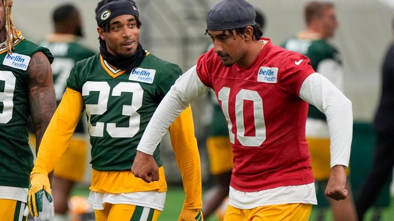 Green Bay Packers' Jordan Love talks to Jaire Alexander during...