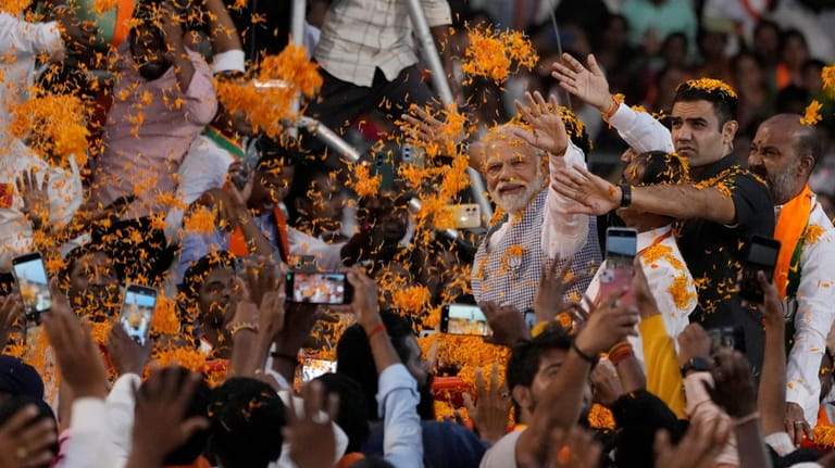 FILE-Indian Prime Minister Narendra Modi greets supporters as he arrives...